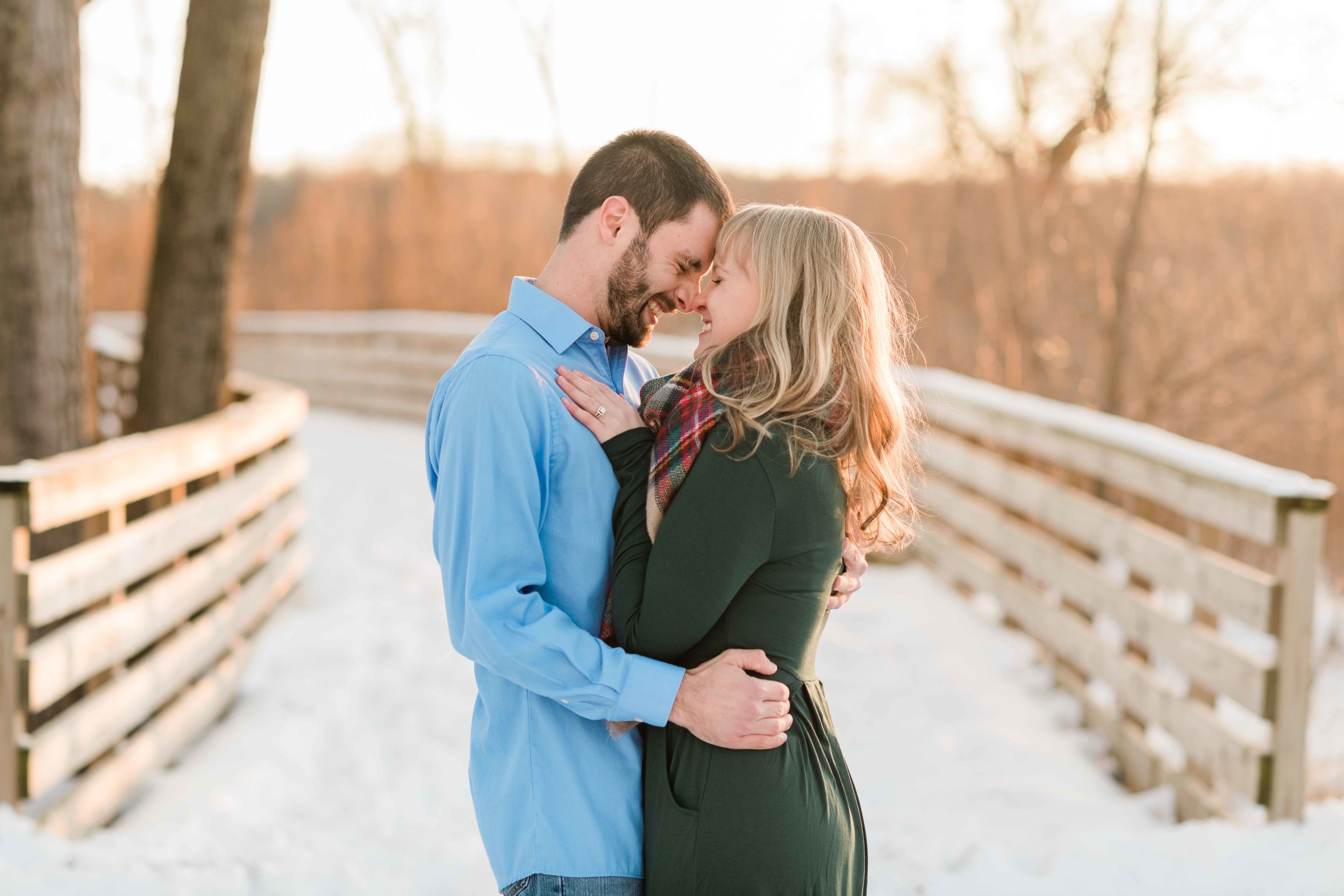 Engaged couple stands forehead to forehead