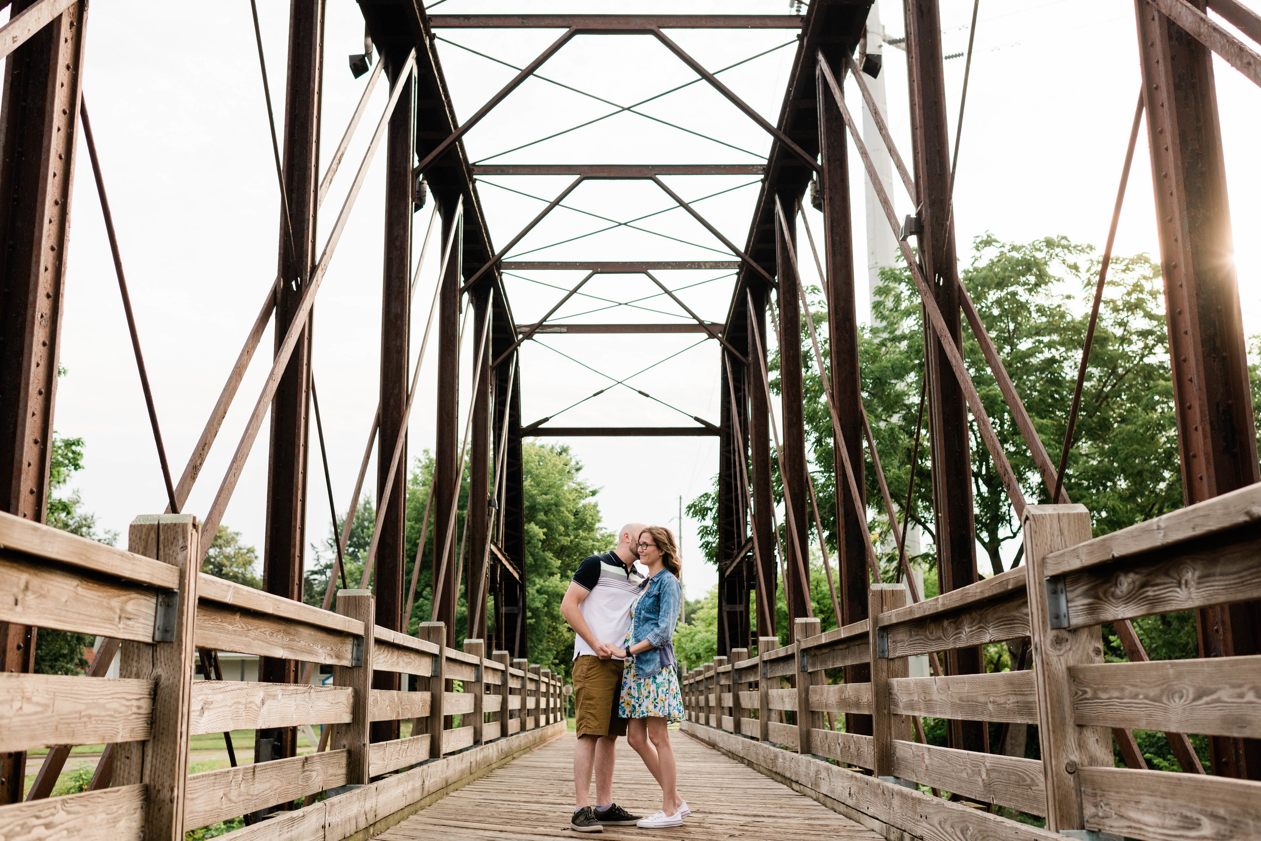 Engaged couple on a bridge