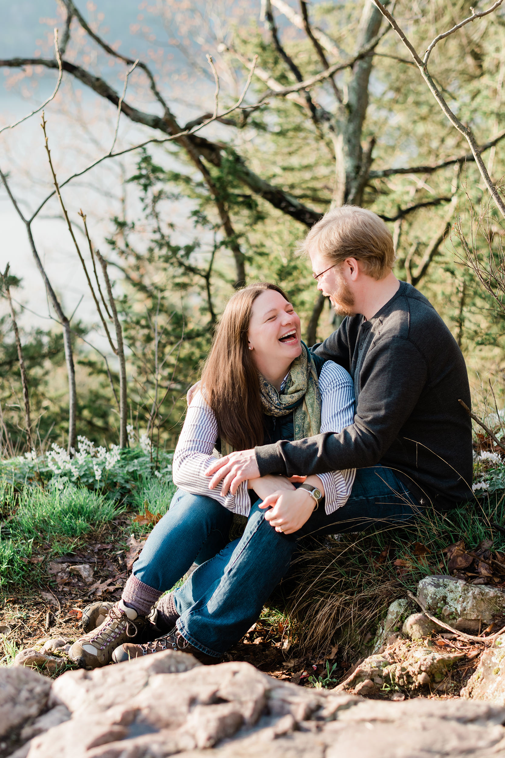 Engaged couple sitting at Devil's Lake State Park