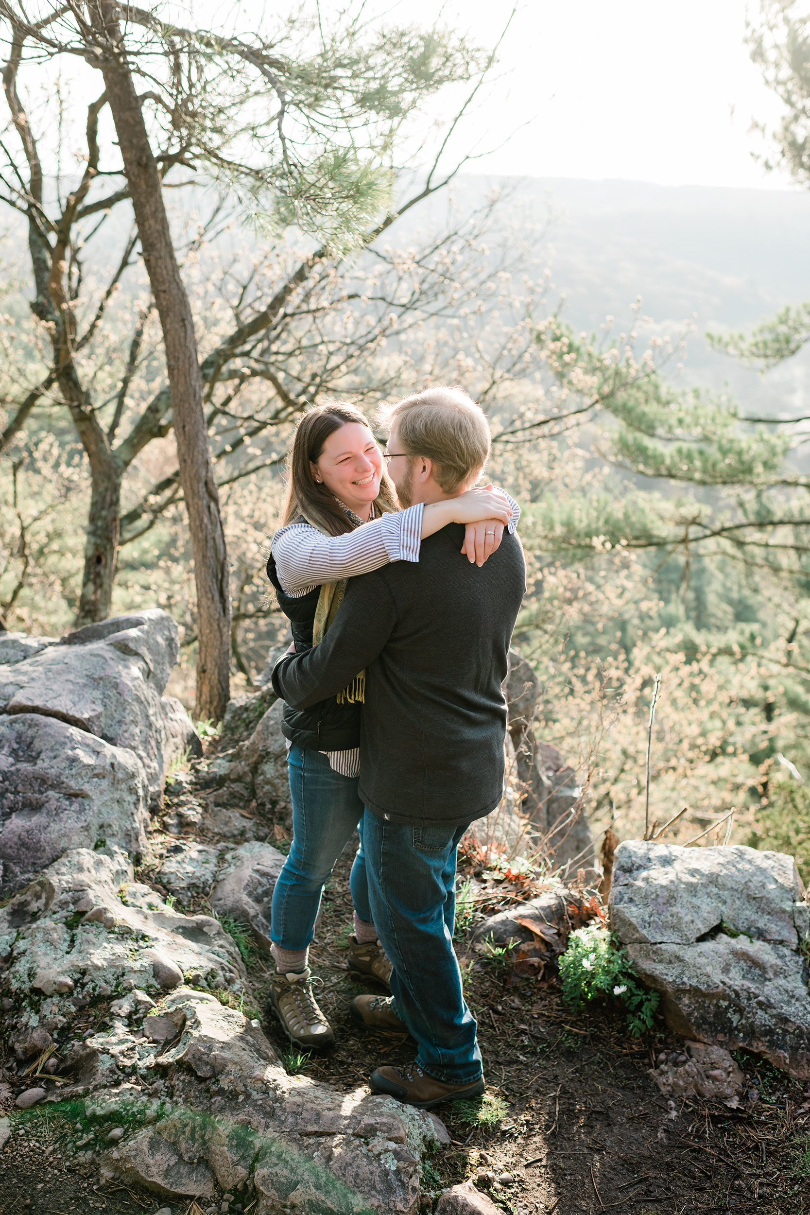 Woman wraps arms around fiancé