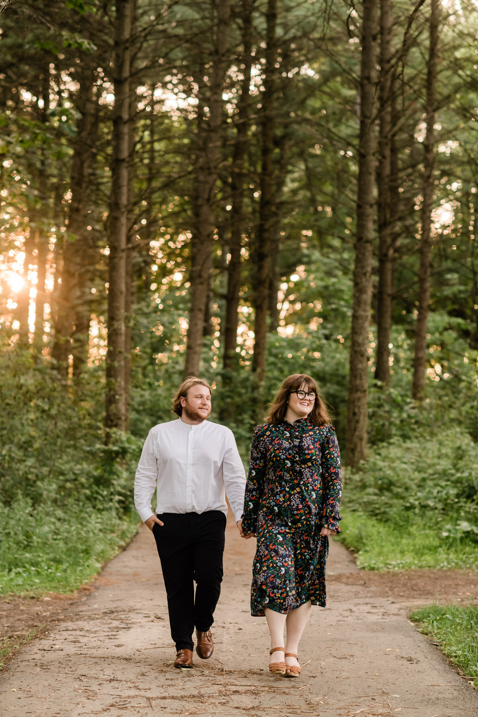 Engaged couple walking in the woods