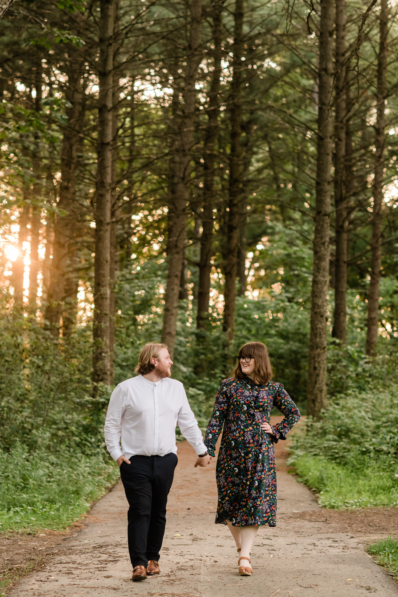Engaged couple smiling in the pines