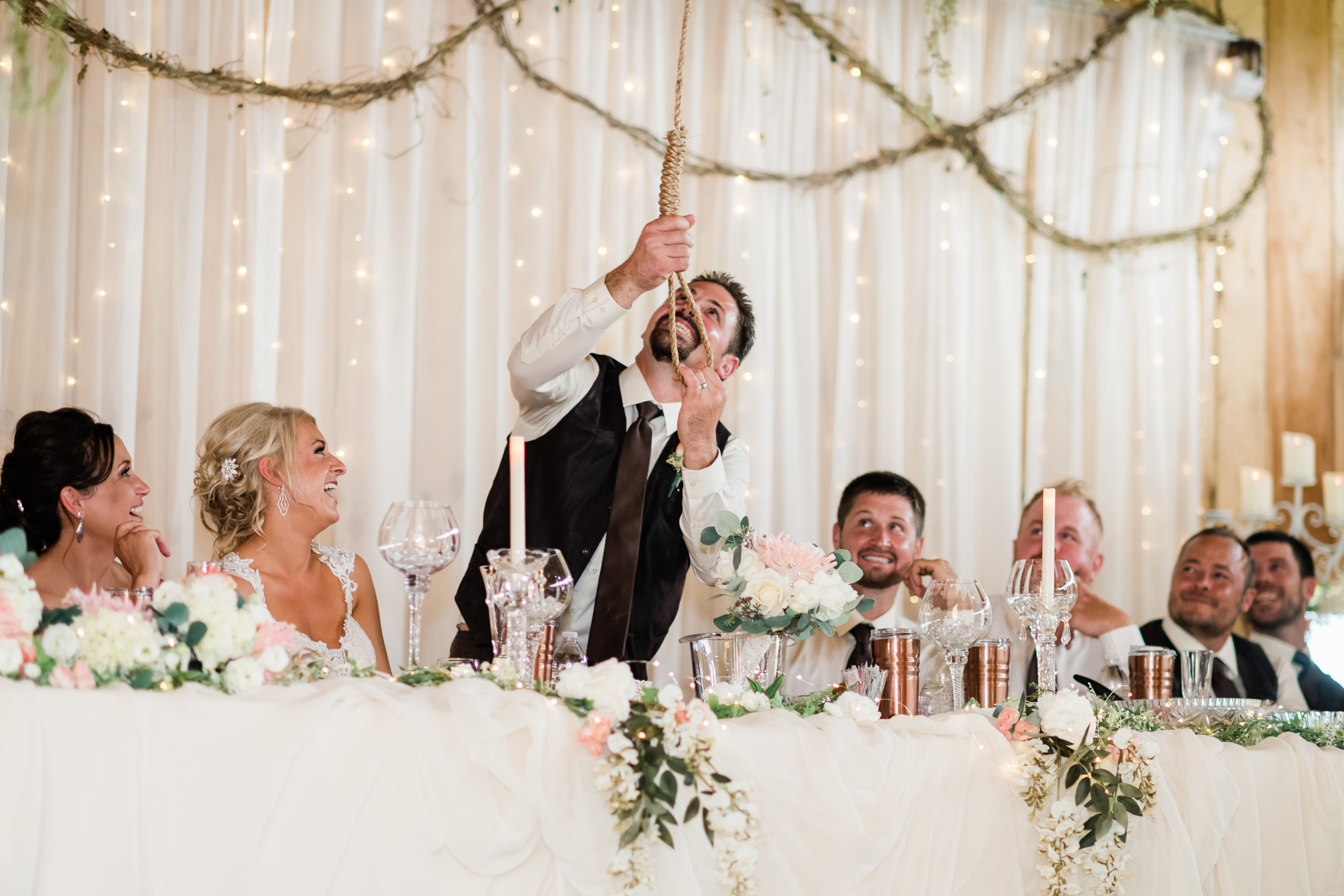Groom pulling on noose