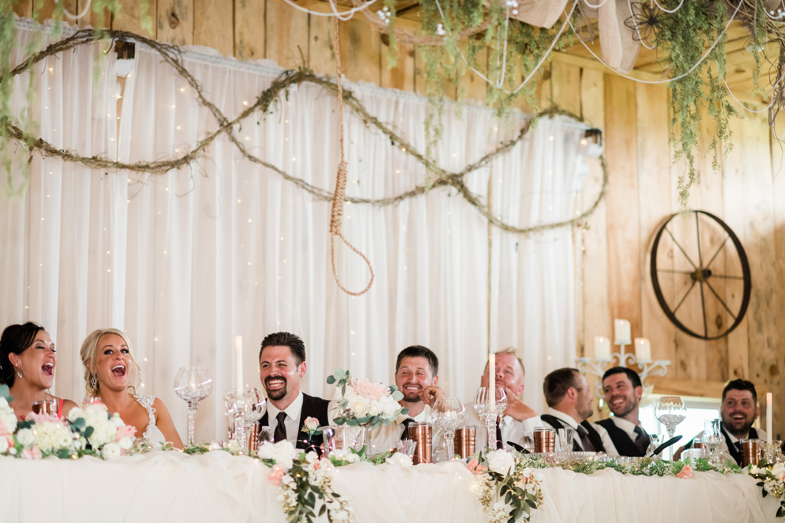 Head table laughing at noose hanging from the ceiling