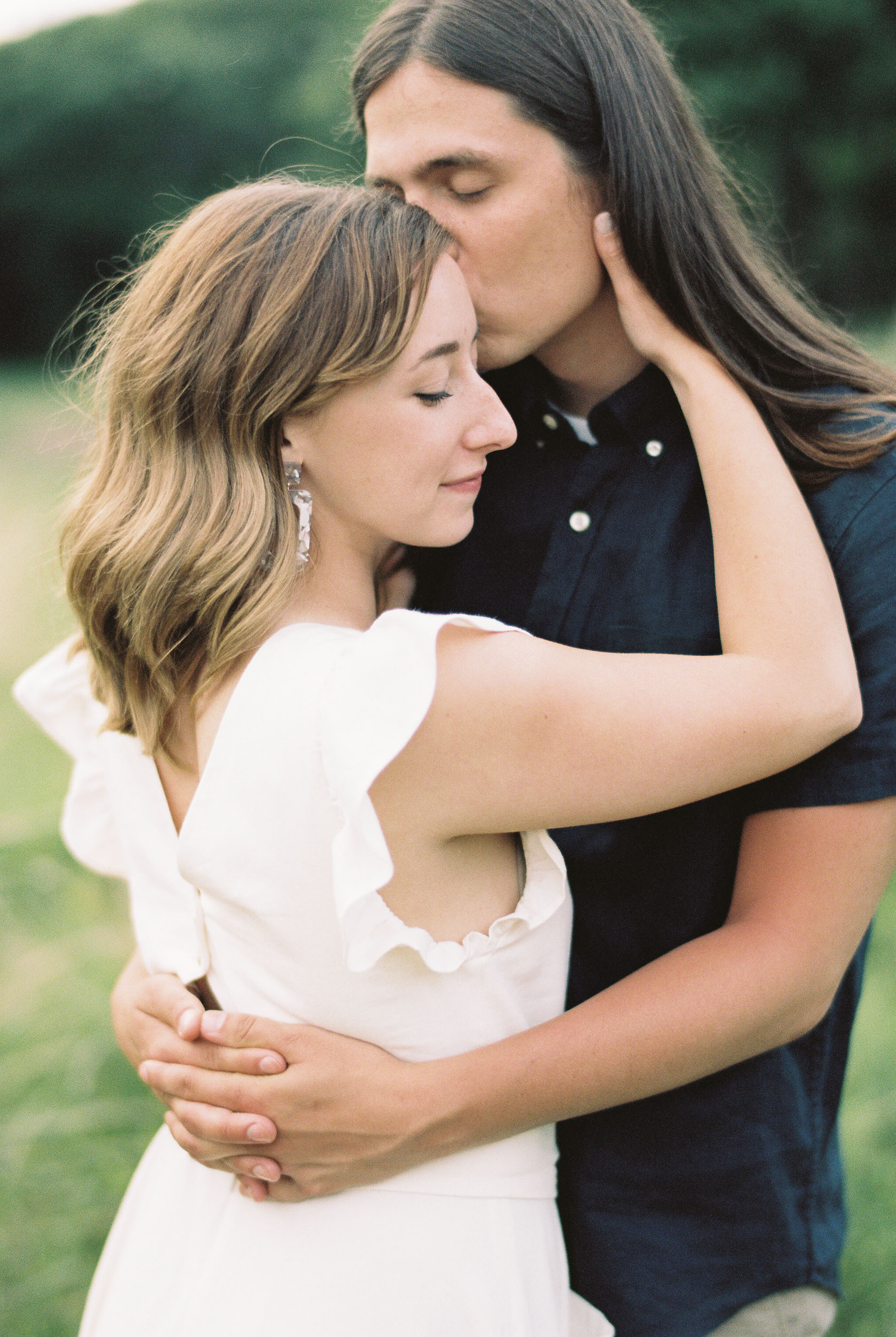 Engaged couple holding each other