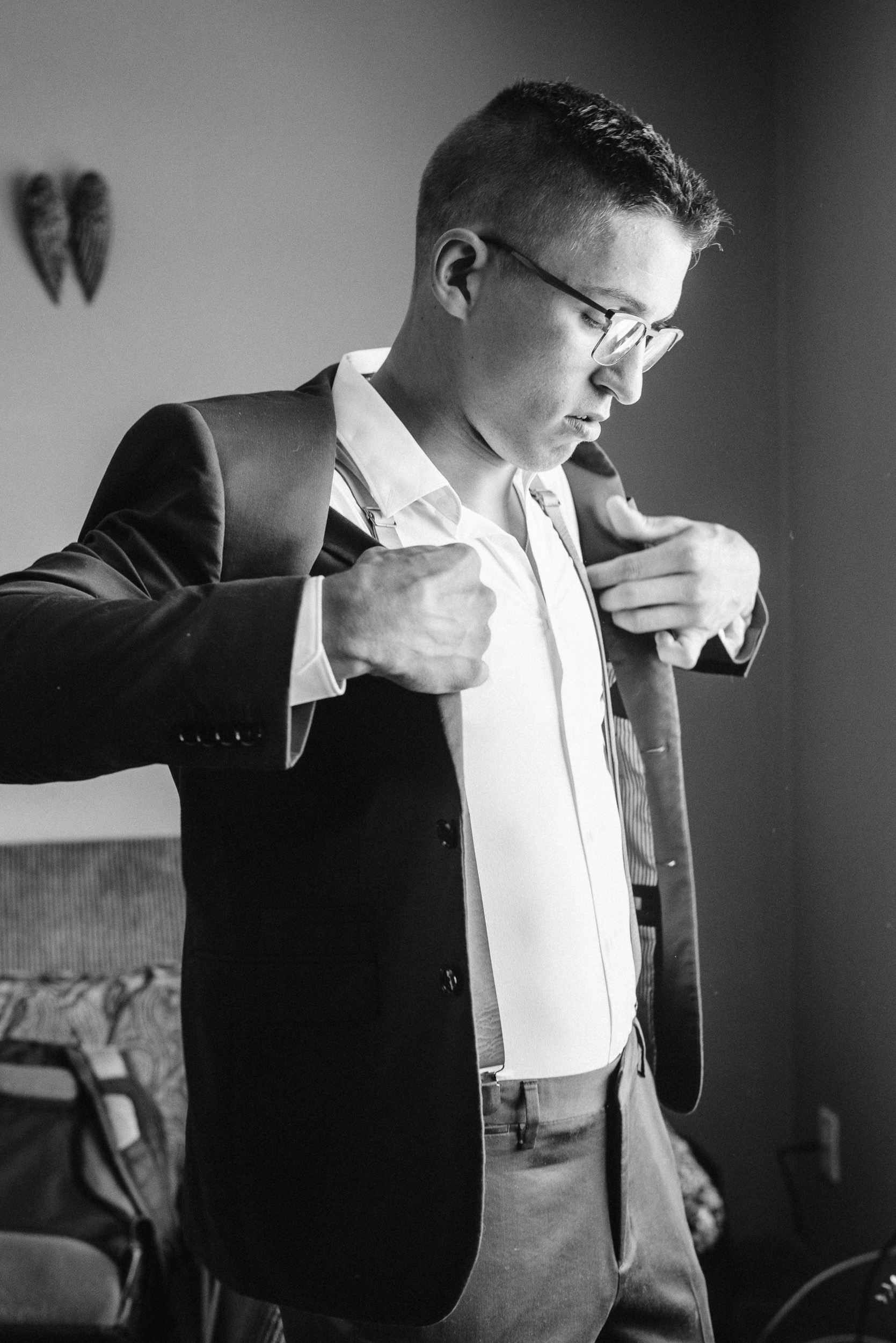 Groom putting on his jacket