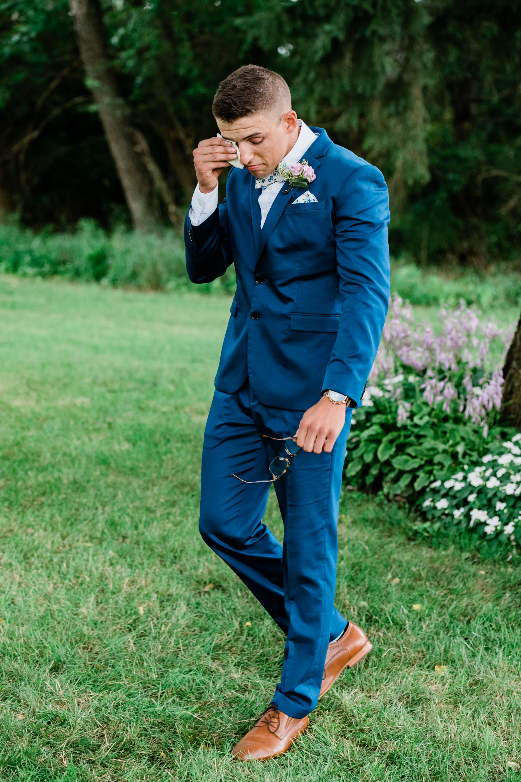 Groom crying as bride walks down the aisle