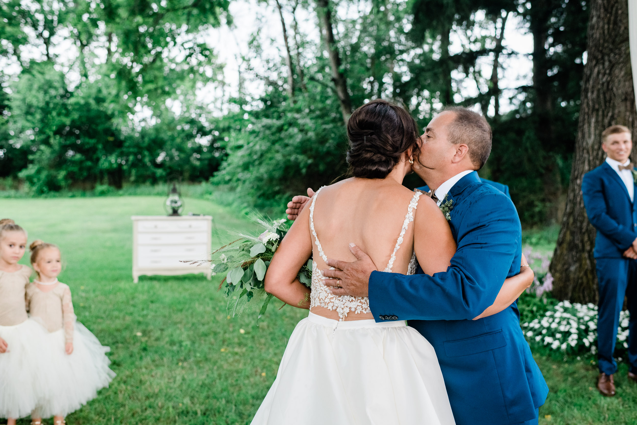 Father of the bride hugging his daughter