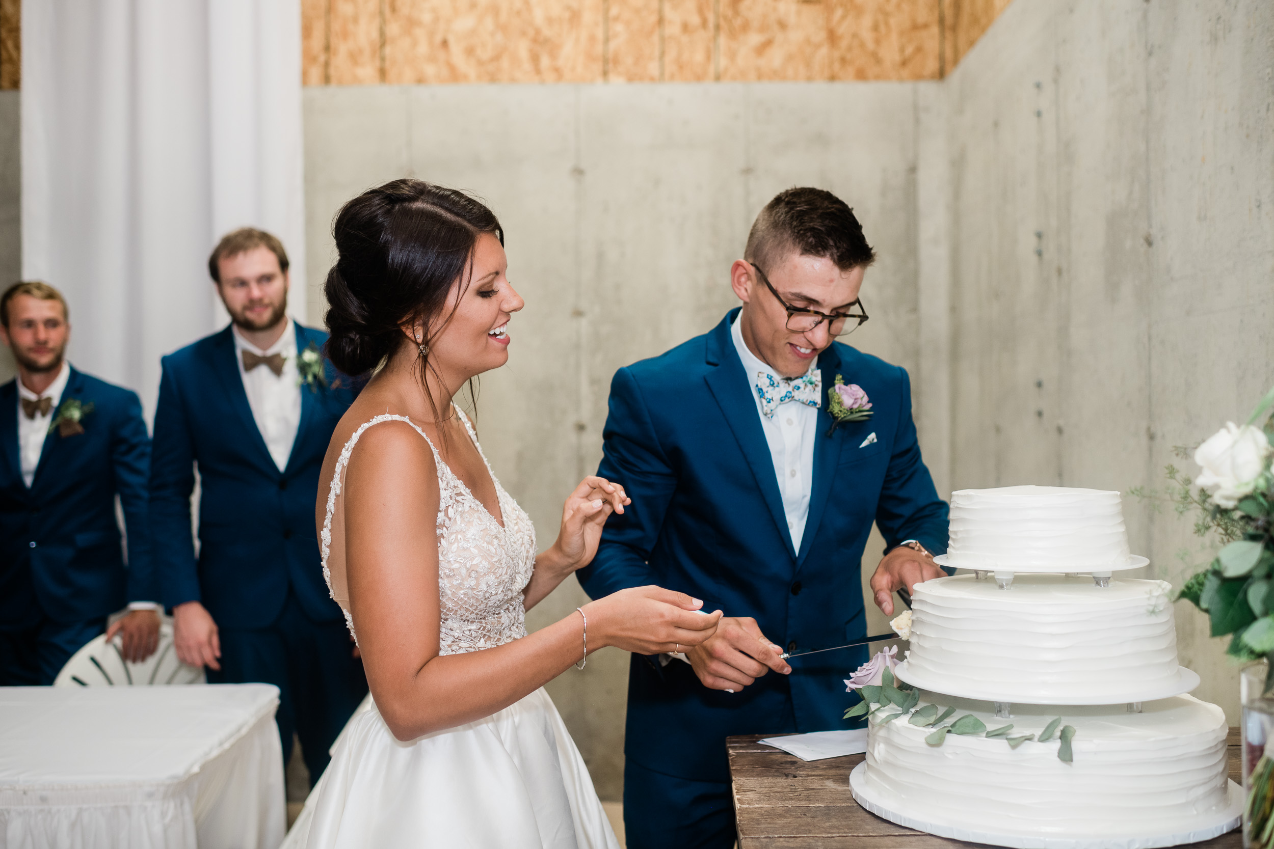 Bride and groom cutting cake