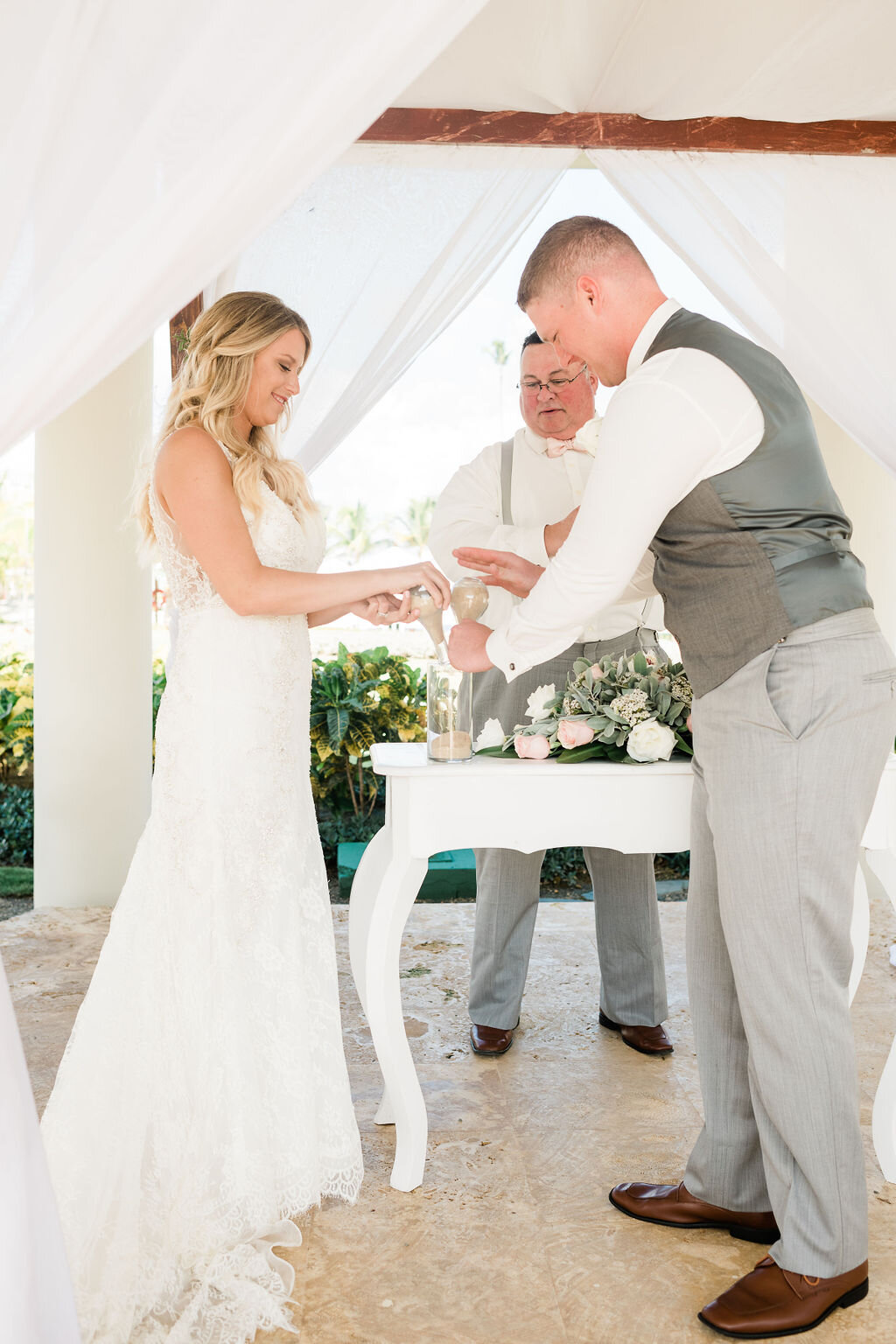 Bride and groom pouring sand in a unity ceremony