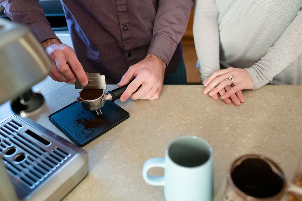 Man leveling off a scoop of espresso