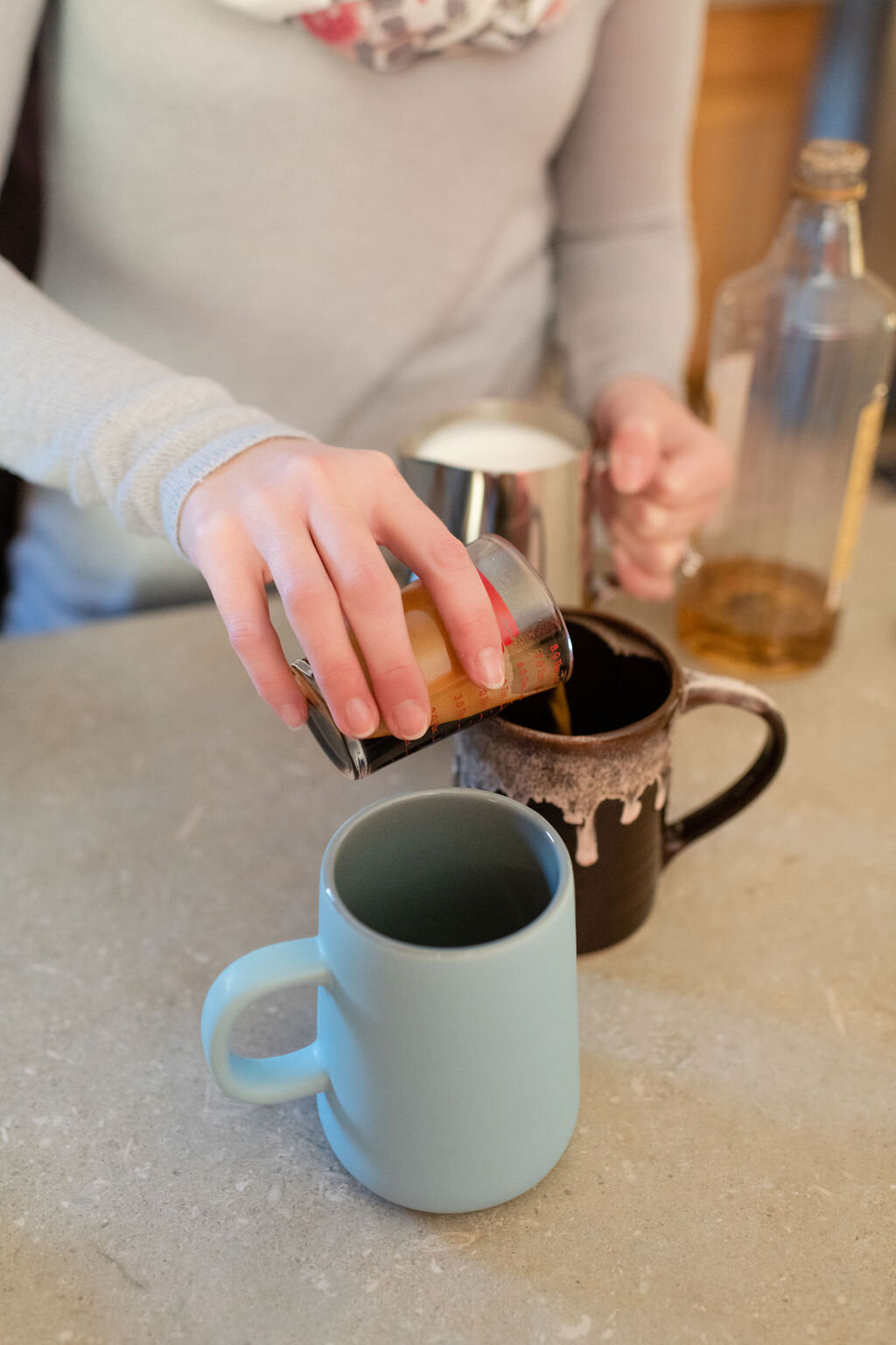 Woman pouring espresso into a mug