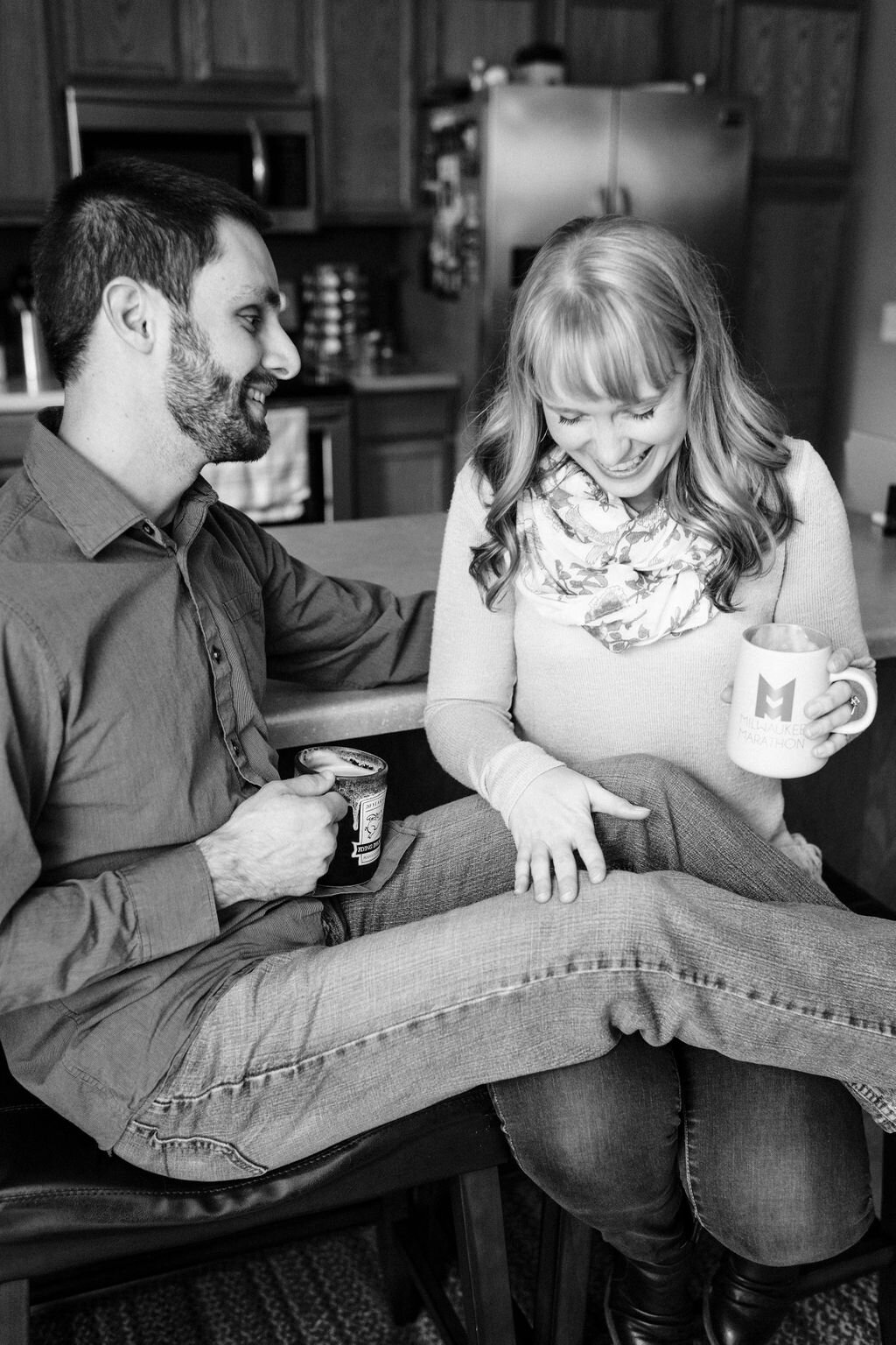 Engaged couple laughing over lattes