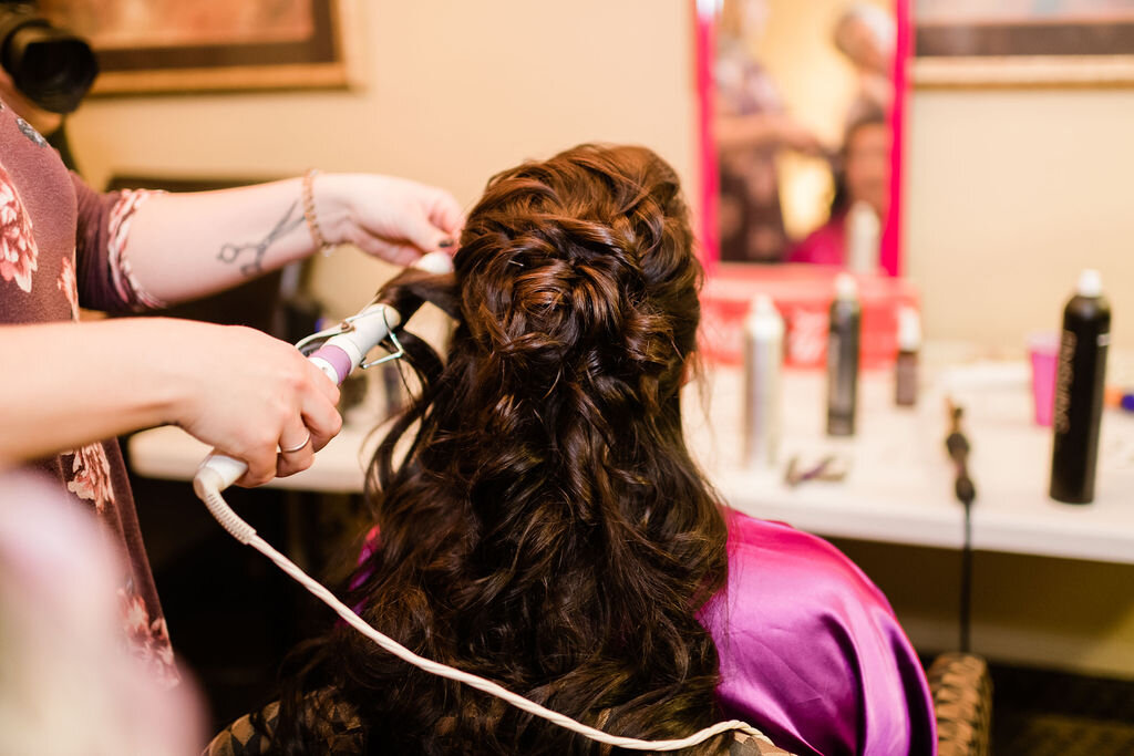 Bride getting hair curled