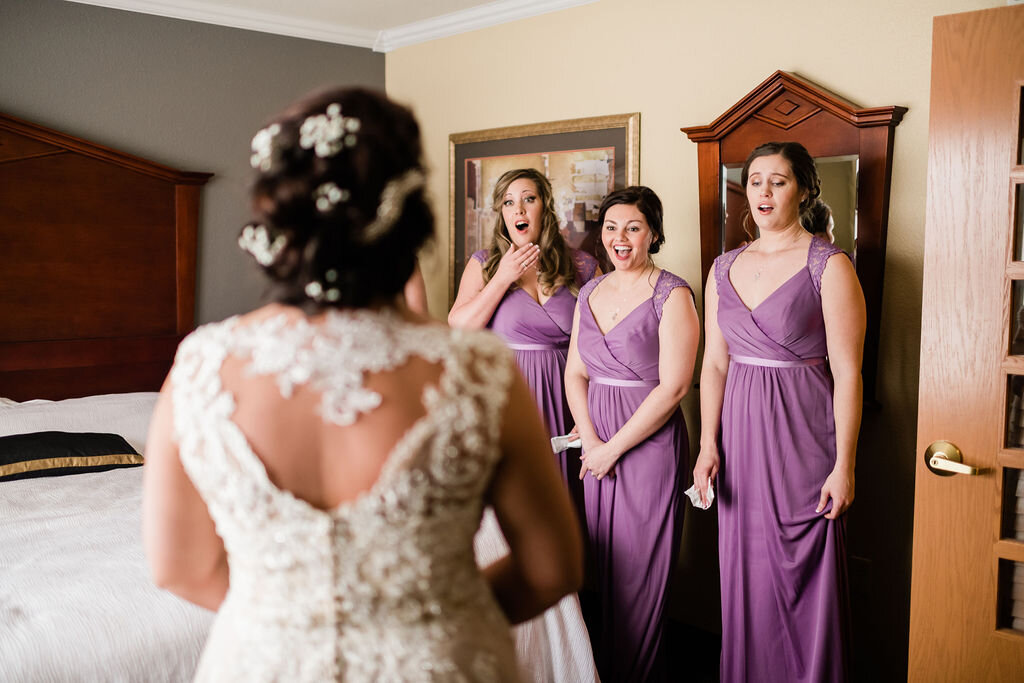 Bridesmaids seeing bride for the first time on her wedding day