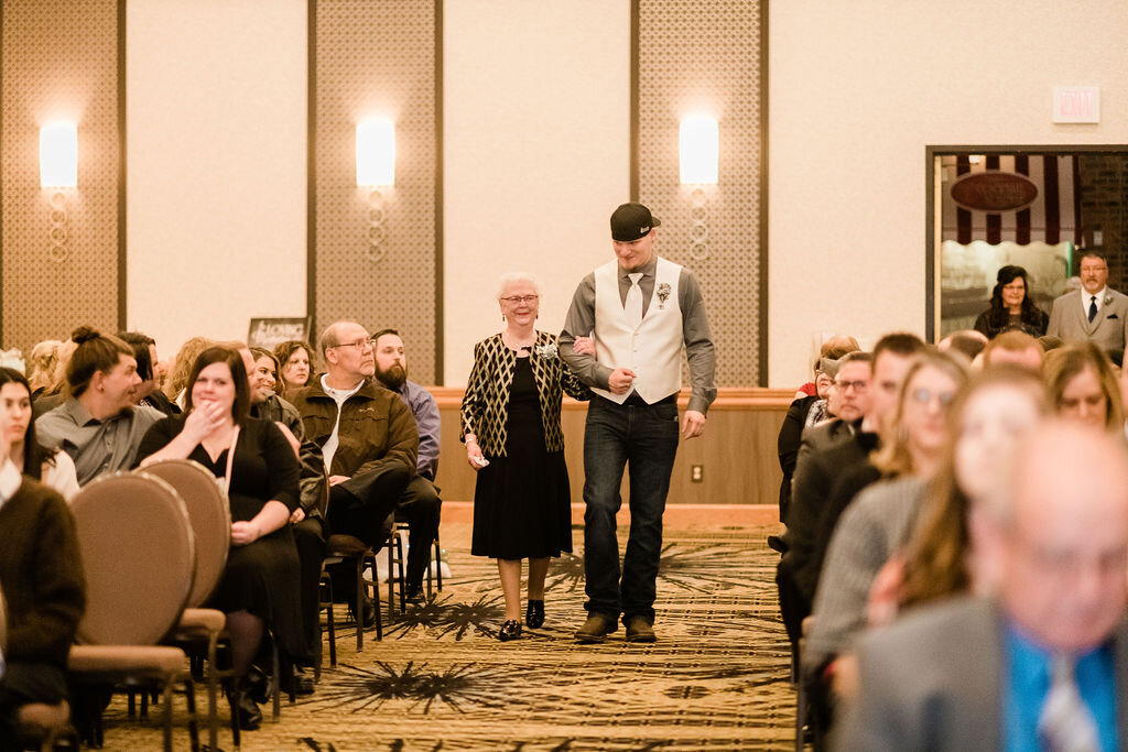 Groom walking grandma down the aisle