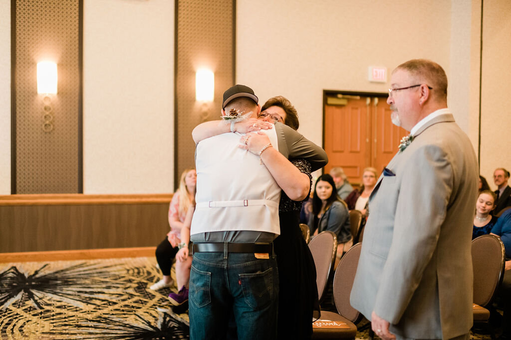 Groom hugging mom