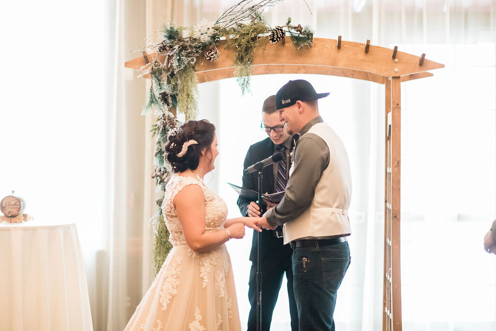 Bride putting ring on groom's finger