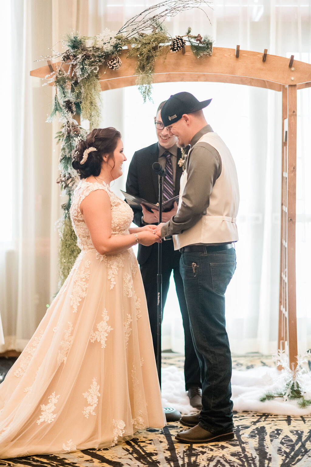 Groom putting ring on bride's finger