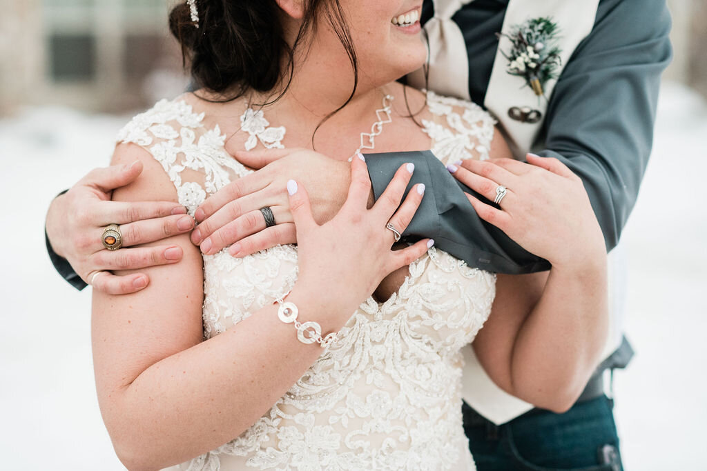 Groom wrapping his arms around bride