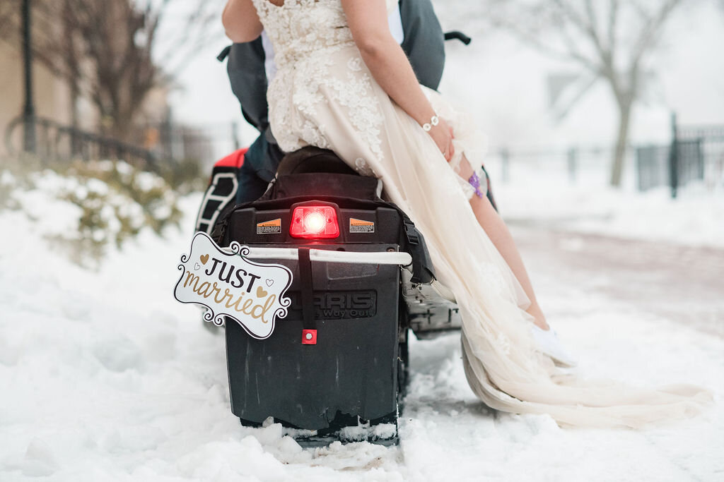 Bride and groom on a snowmobile