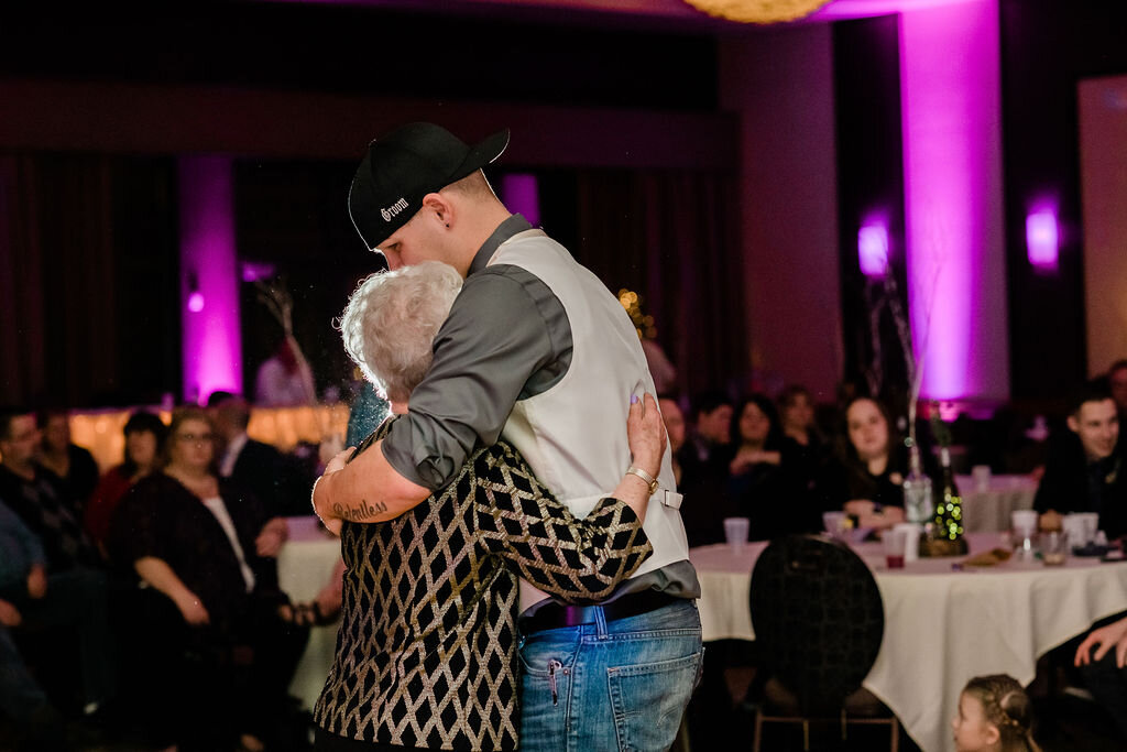 Groom hugging his grandmother on the dance floor