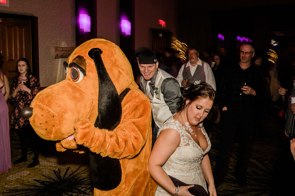 Bride and groom dancing with Goofy