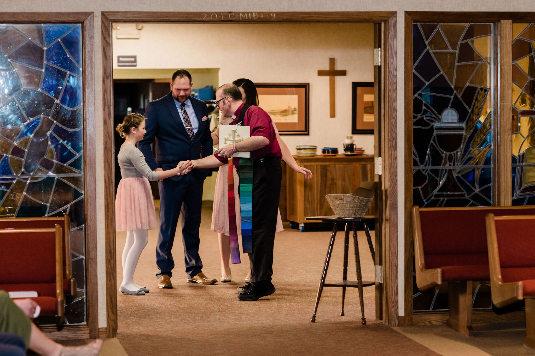 Pastor shaking hands with groom's child