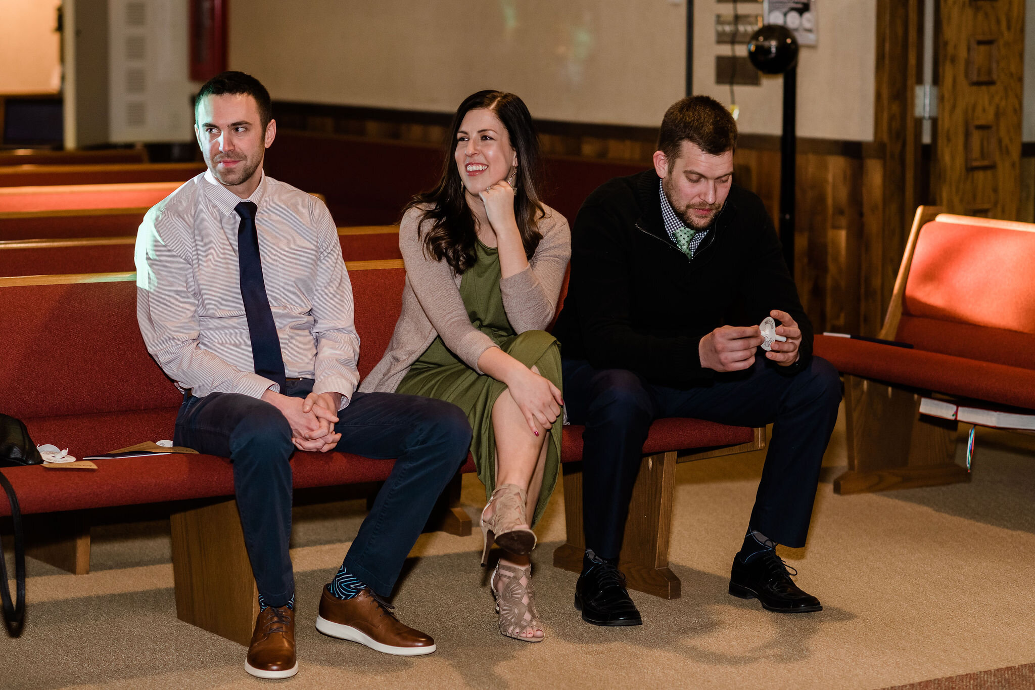 Wedding guests laughing in church