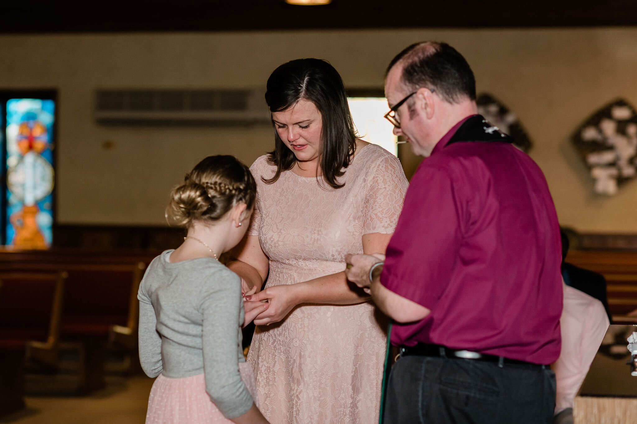 Bride and stepdaughter exchanging rings