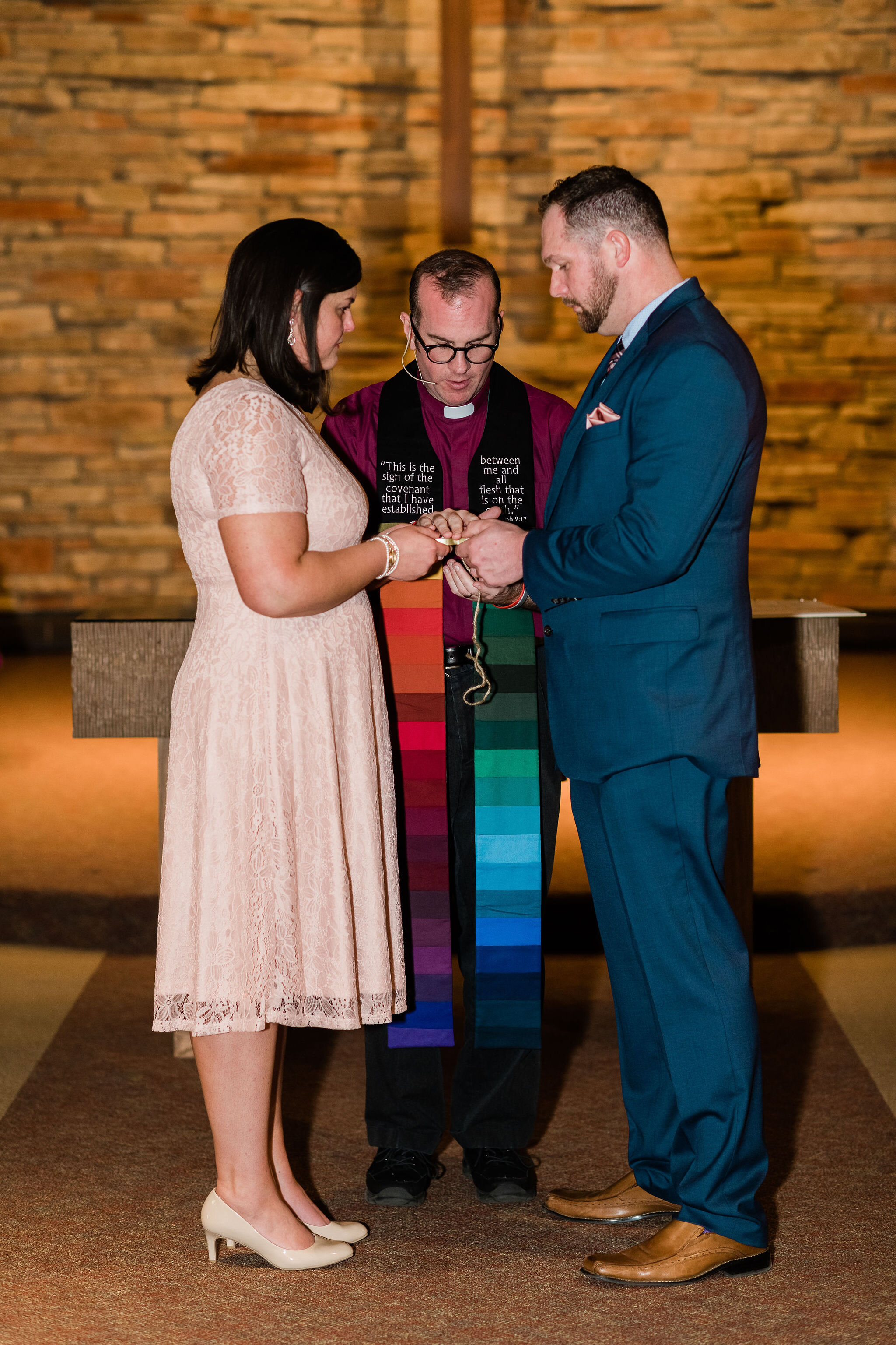 Bride and groom holding rings