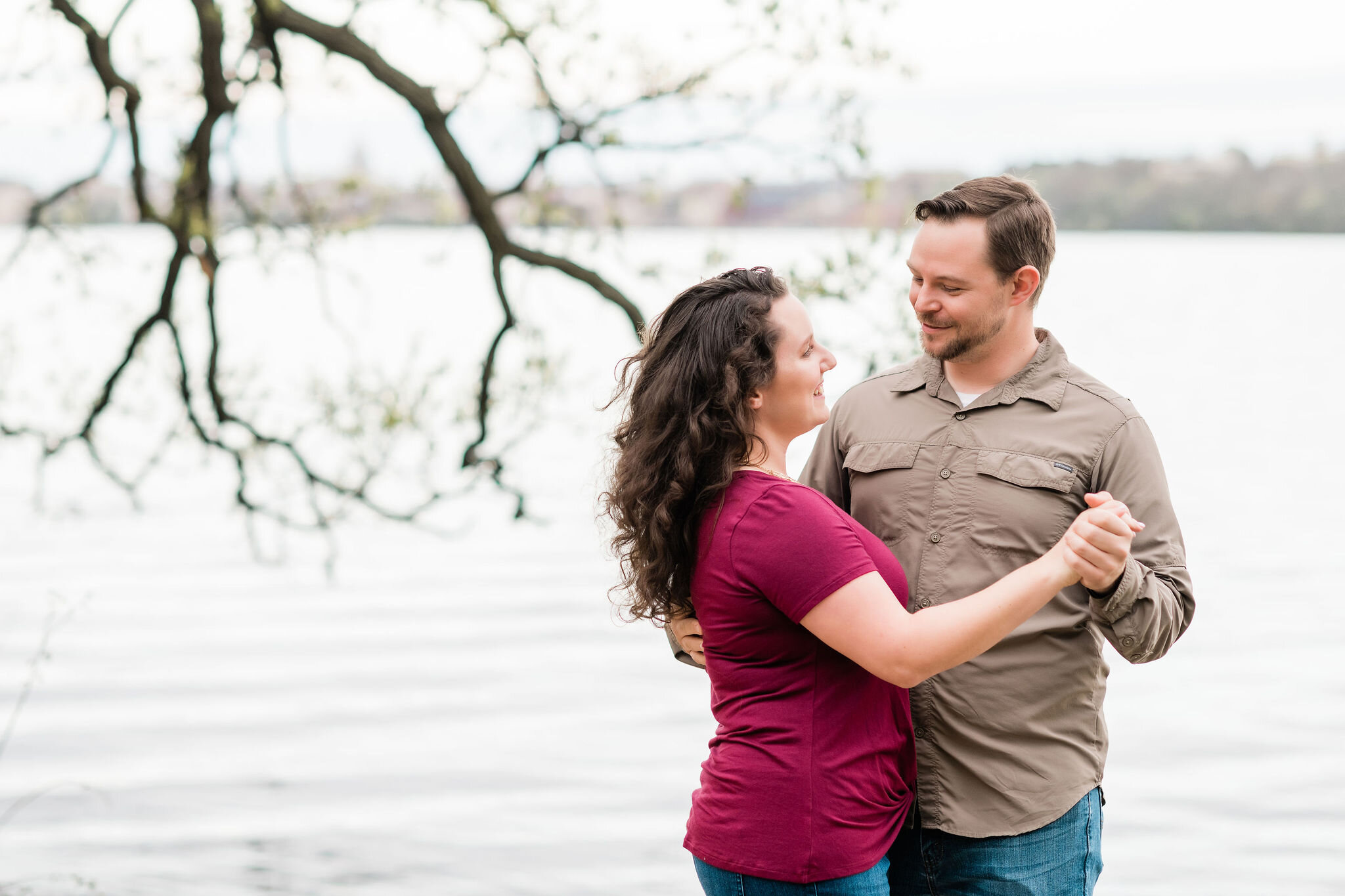 Couple slow dancing in front of the water