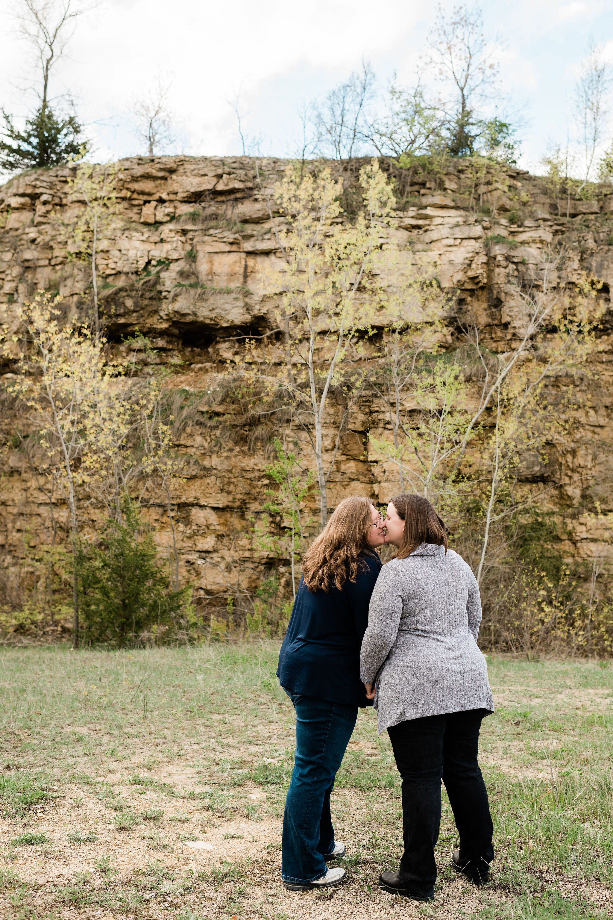 A woman and her fiancé kiss