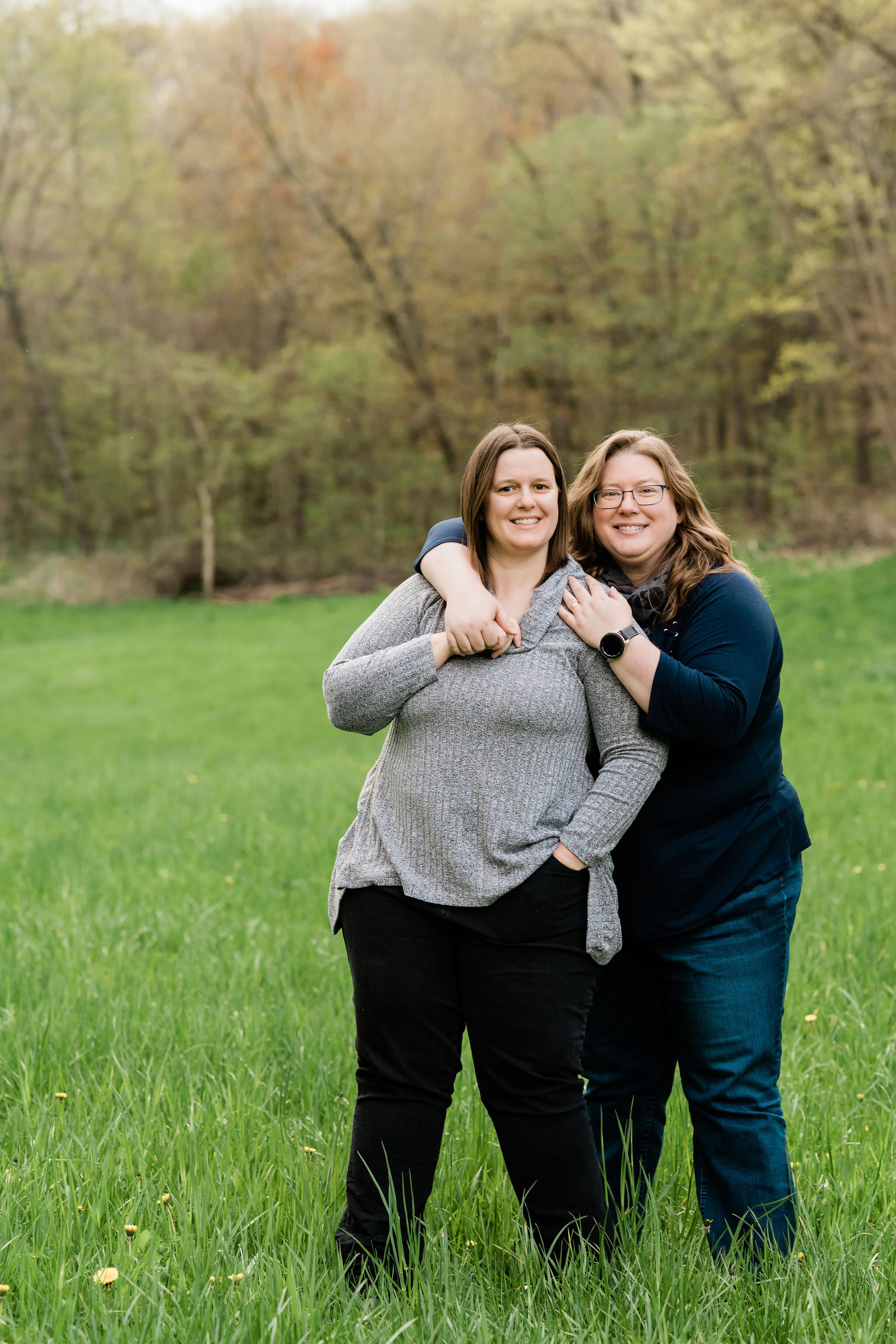 Woman wraps her arms around her wife