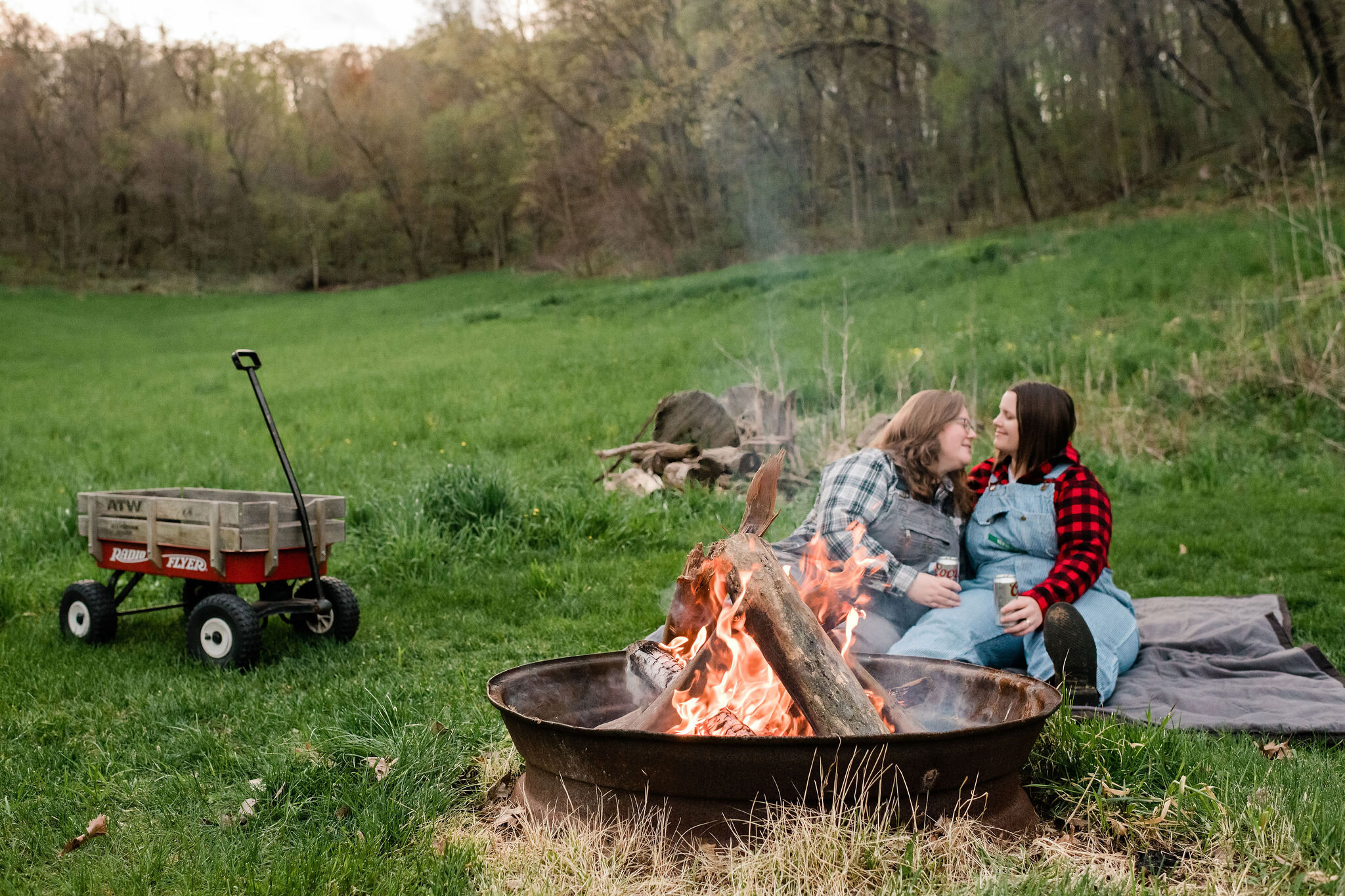 Engaged couple enjoying a bonfire