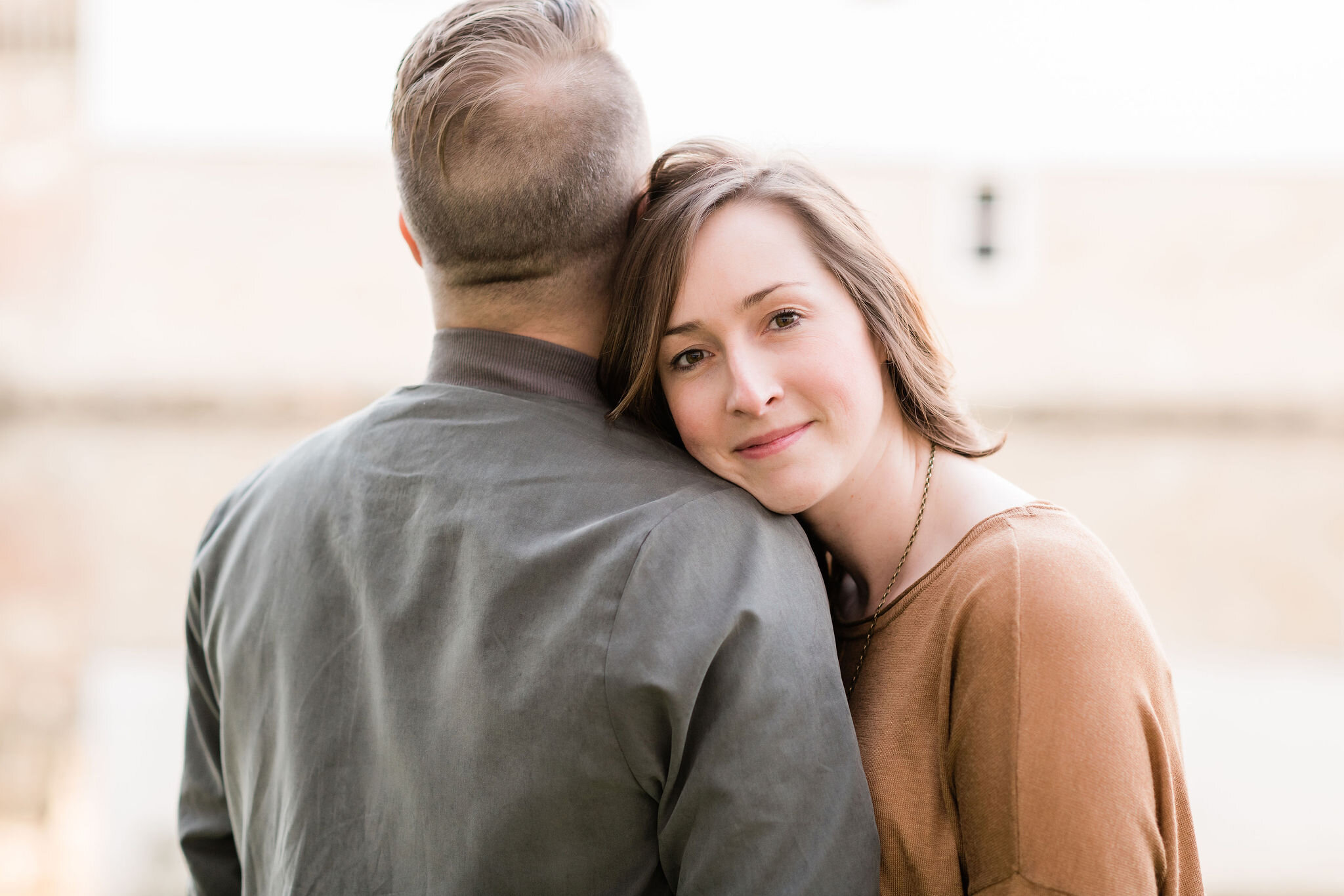 Woman rests her head on her fiancé's shoulder