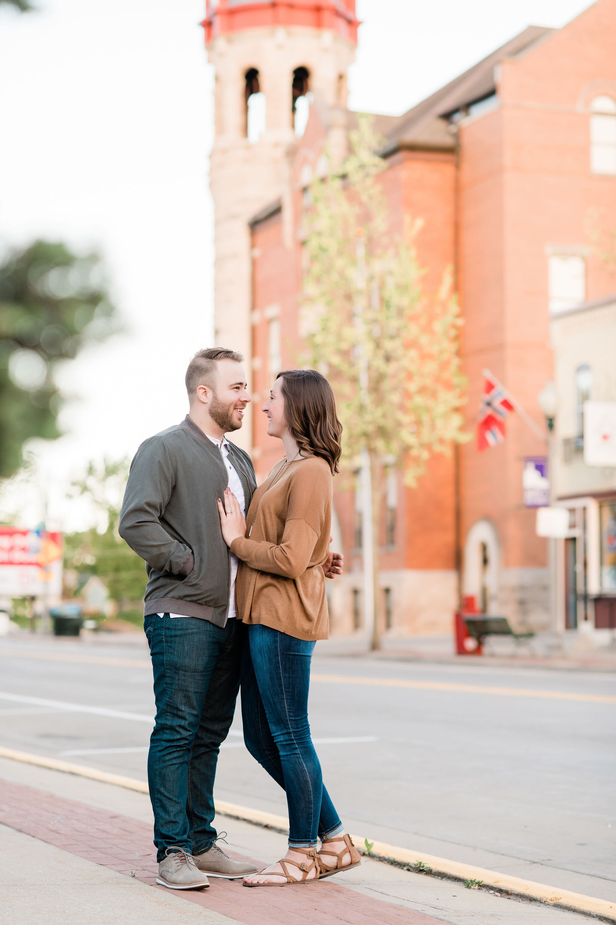 Engaged couple in front of a clock tower