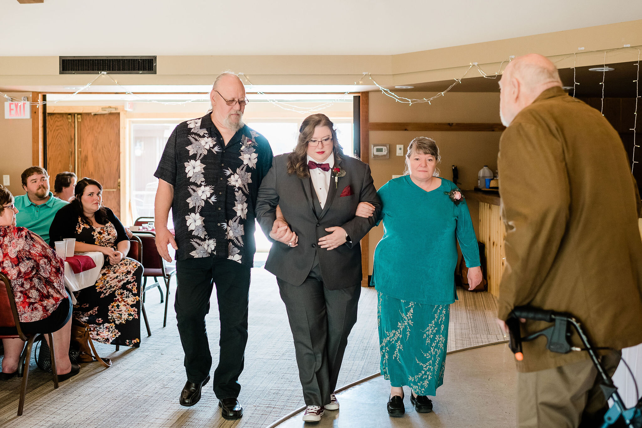 Bride walking down the aisle with her parents