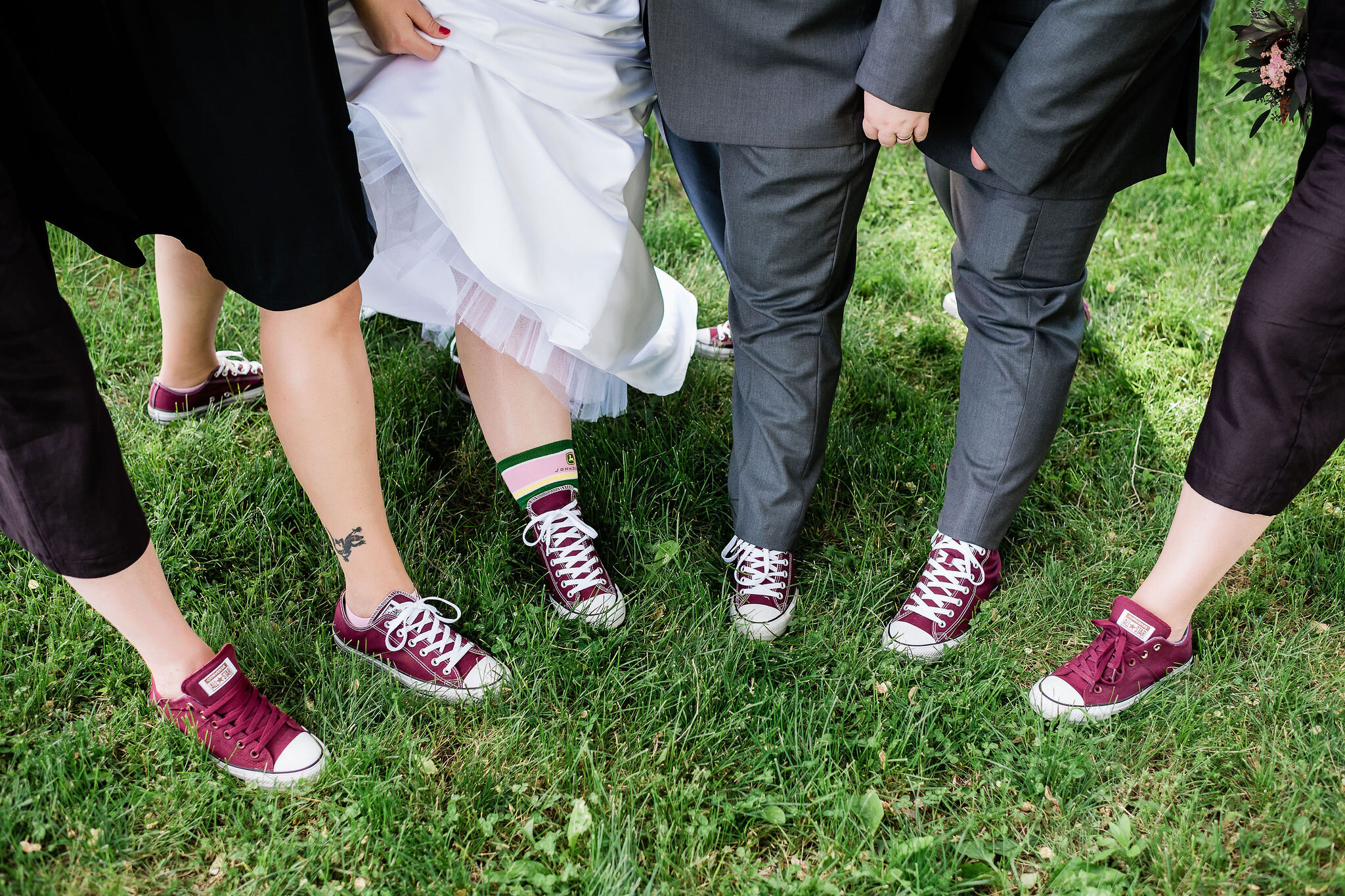 Wedding party showing their Converse sneakers