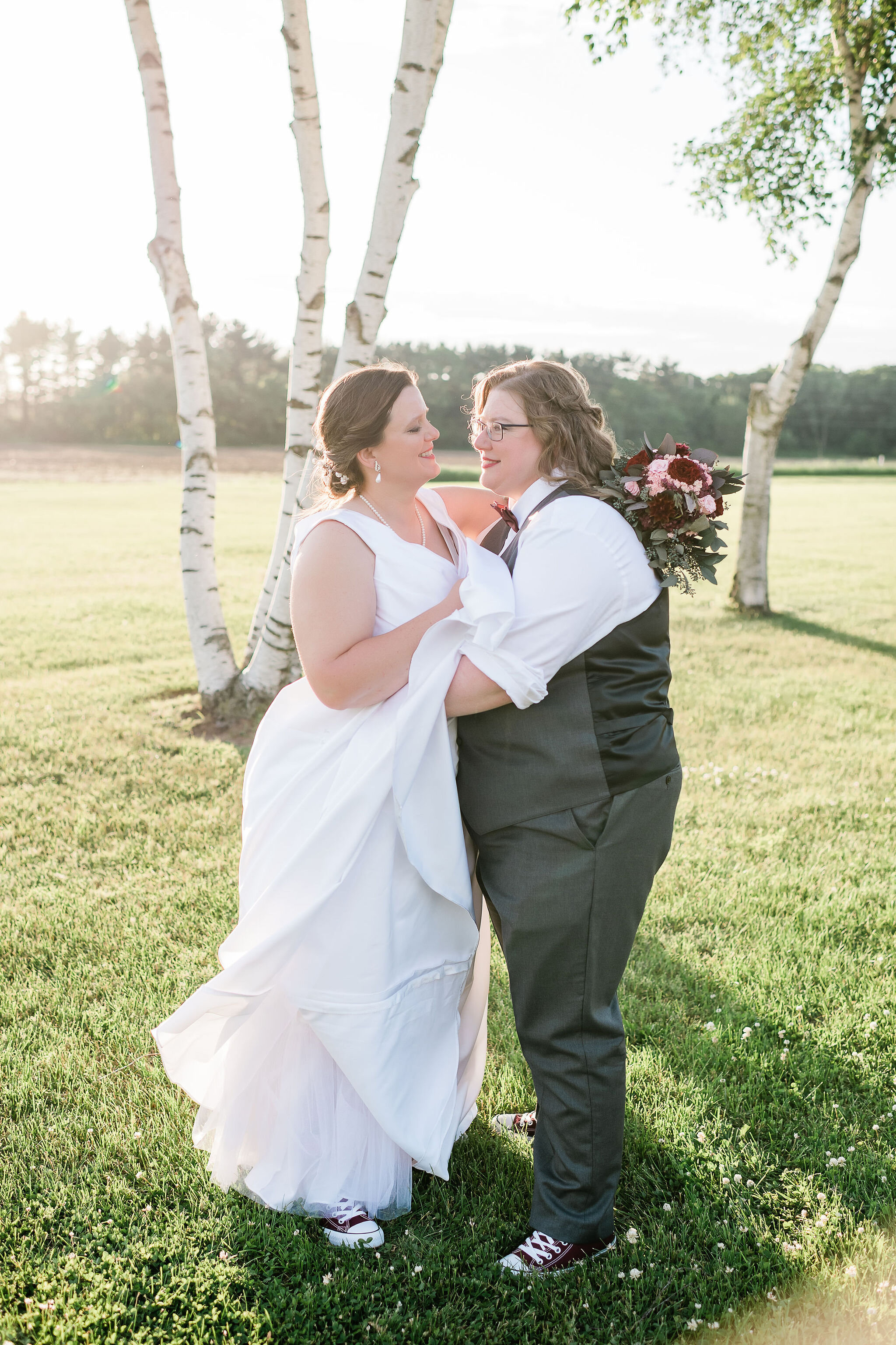 Brides dancing in front of birch trees