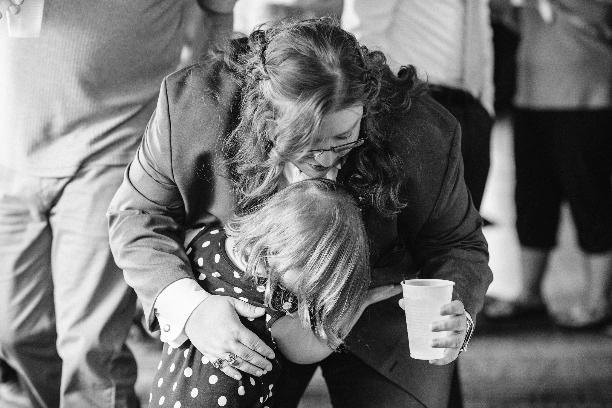 Bride hugging a child at her wedding