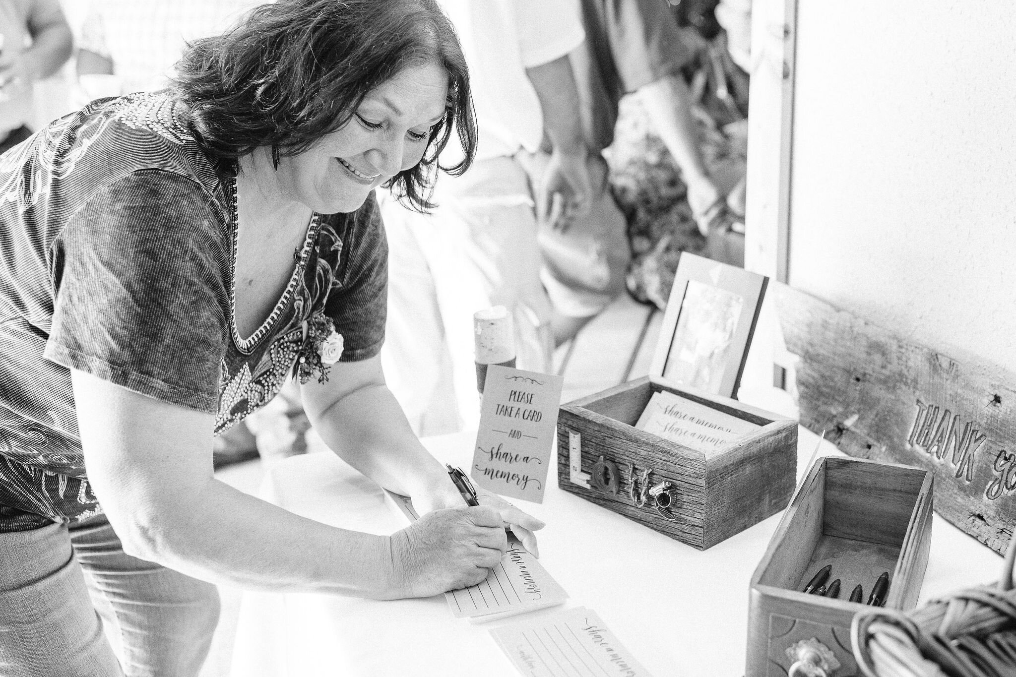 Woman signing wedding guest book