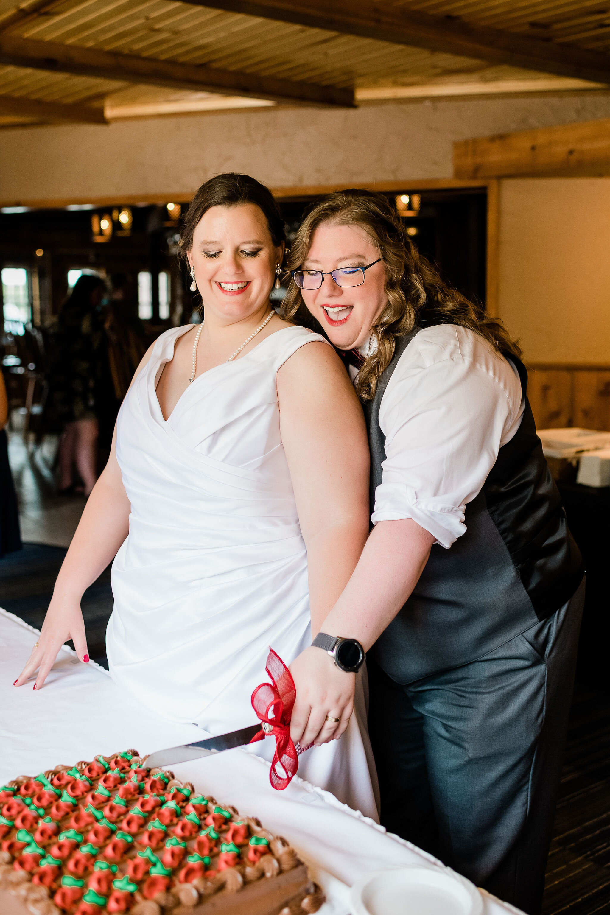 Brides cutting their wedding cake