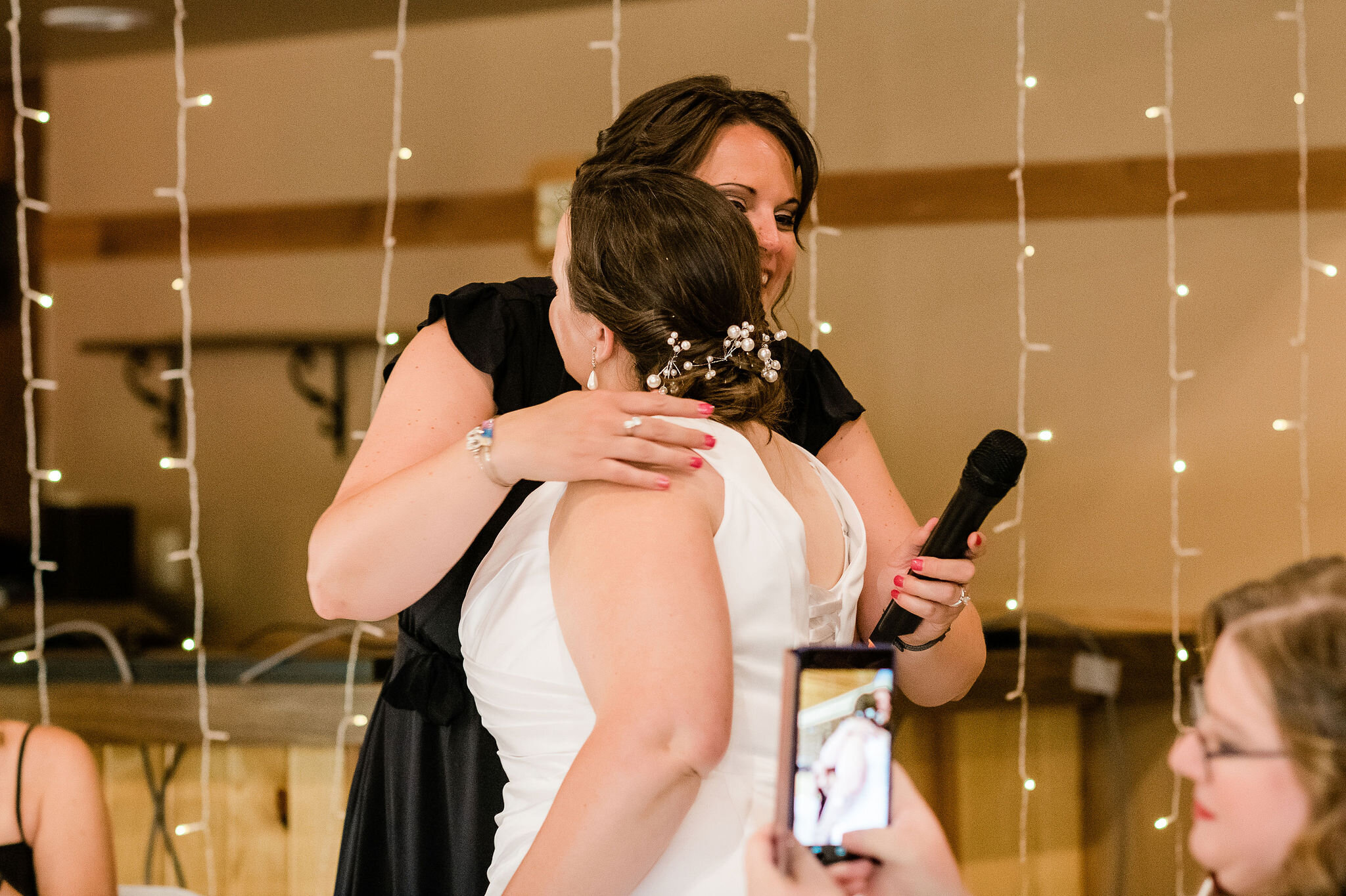 Bride hugging maid of honor