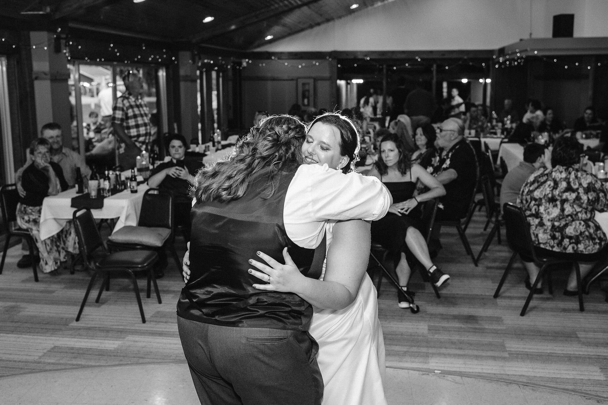 Brides hugging on the dance floor
