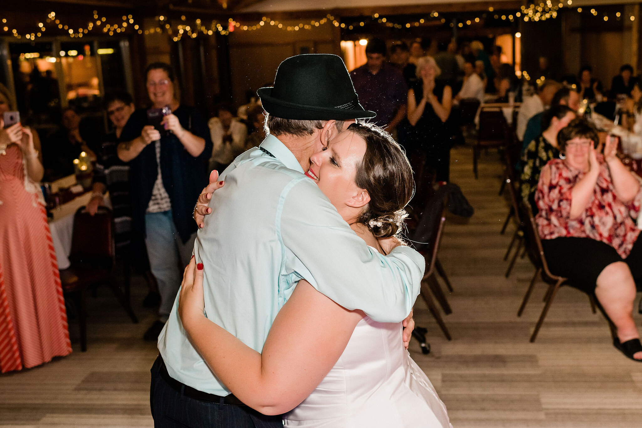 Bride hugs her father on the dance floor
