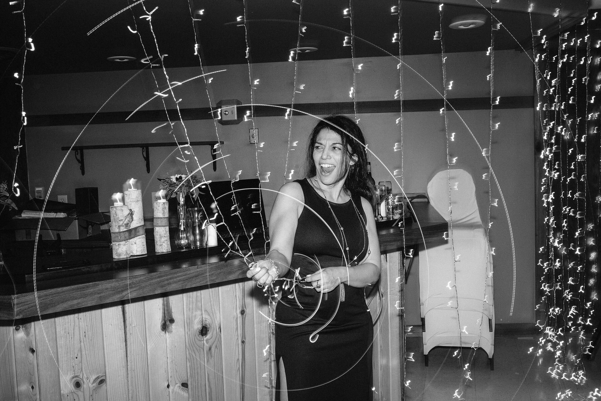 Wedding guest swinging a string of lights