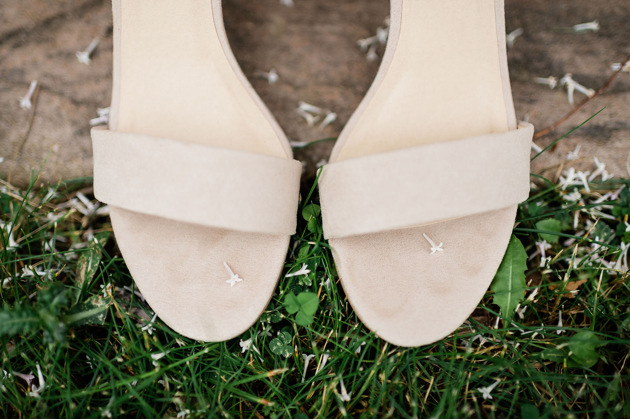 Closeup of bride's shoes with little lilac leaves on them