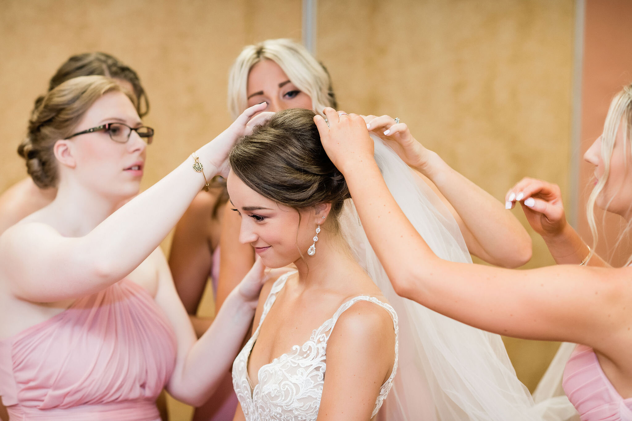 Bridesmaids adjusting the bride's veil