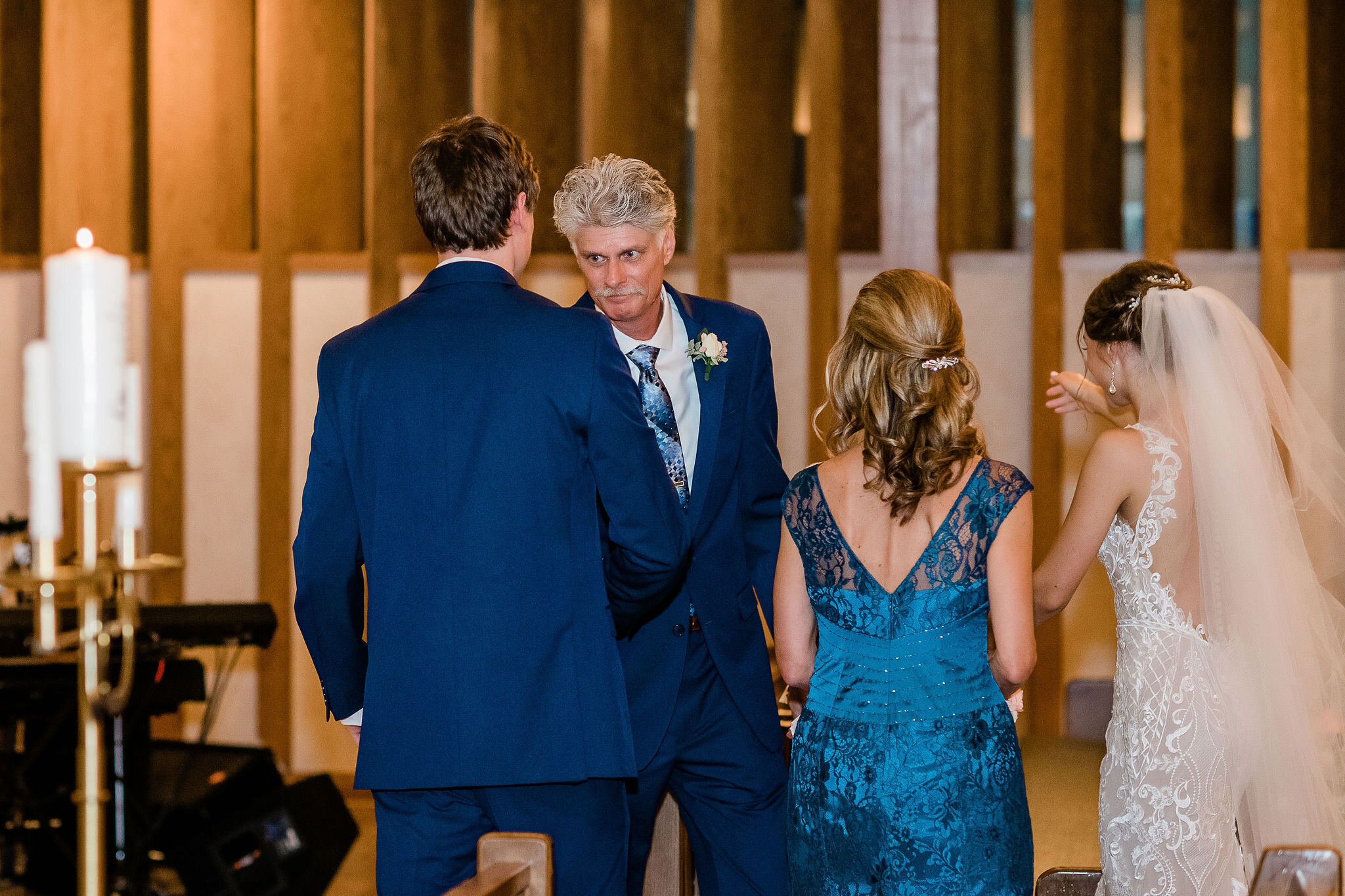 Groom shakes his father's hand